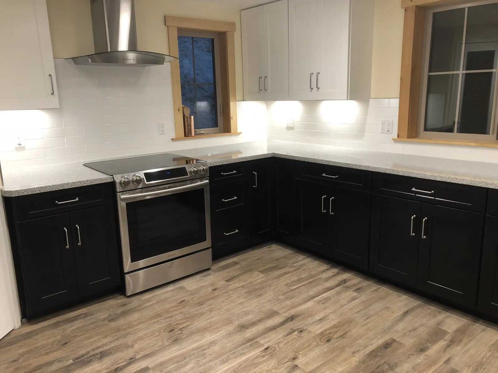 Finished kitchen countertop and white tile backsplash around the cooktop