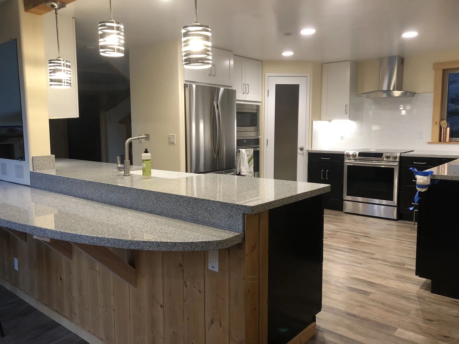 Wide view of a completed kitchen with matching perimeter and island countertops