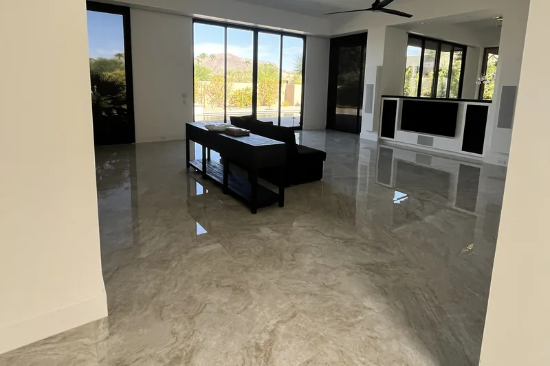 High-gloss Taj Mahal-style porcelain tile flooring reflecting mountain views through sliding glass doors, Palm Desert