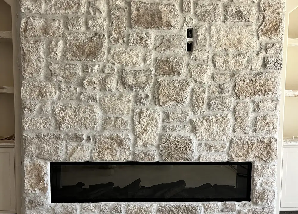 Custom natural stone fireplace wall with linear fireplace, built by My-Key Tile & Flooring