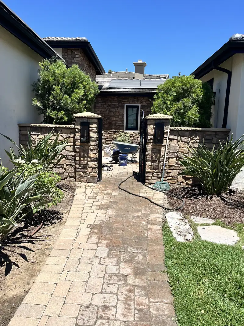 Courtyard paver walkway and stone entrance during renovation work